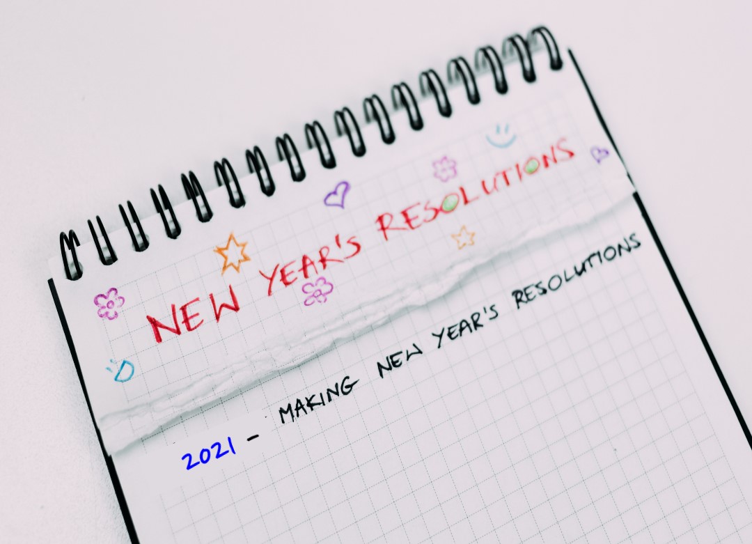 New Year's Resolutions written on spiral pad of graph paper