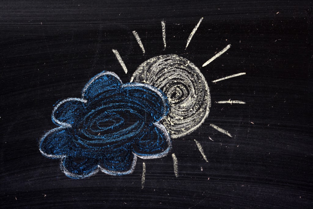 Picture of chalkboard drawing of blue cloud with white outline and sun peaking out from behind - even 2020 had a silver lining